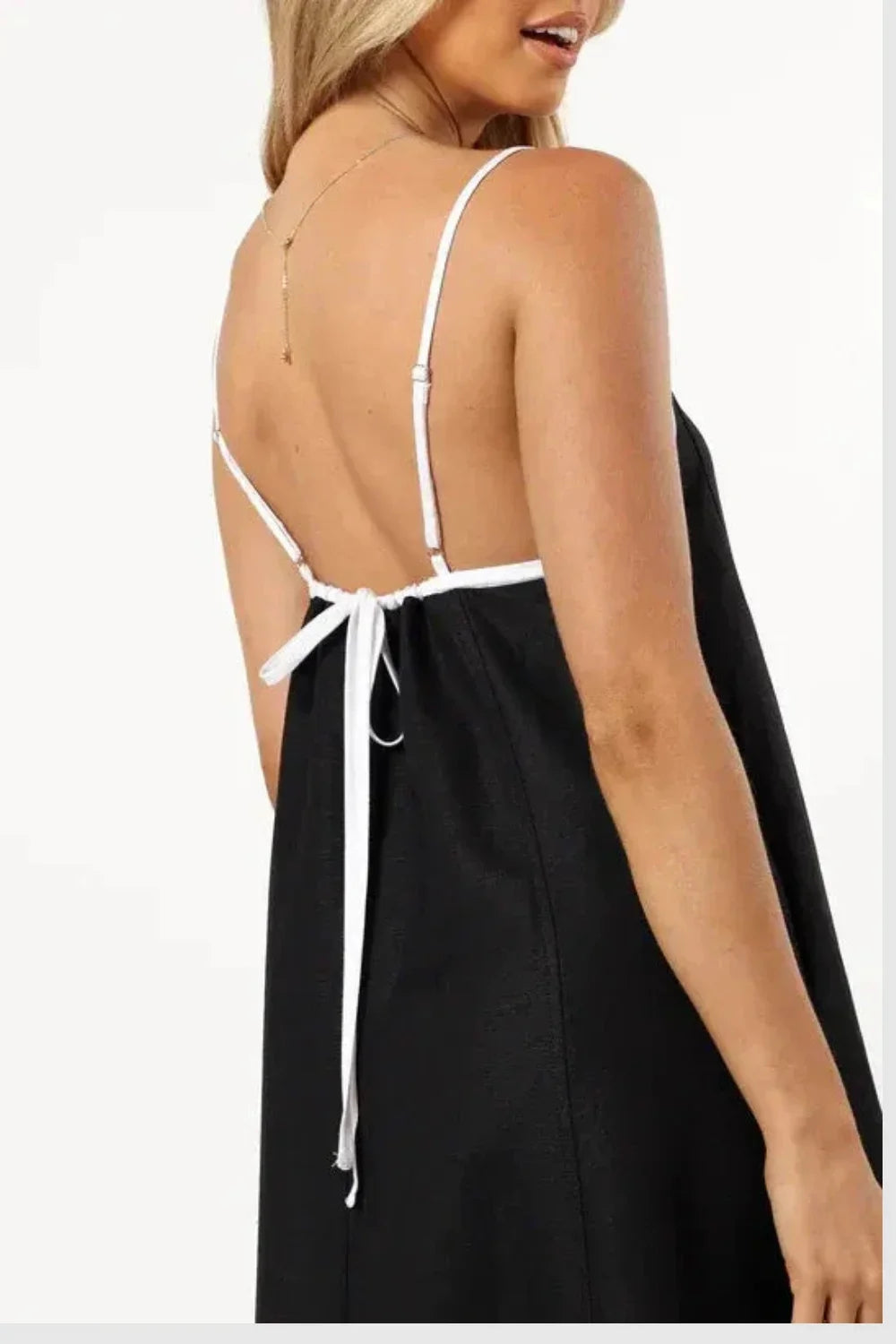 Model wearing Kouvr Fashion black linen maxi dress with white tie-back straps