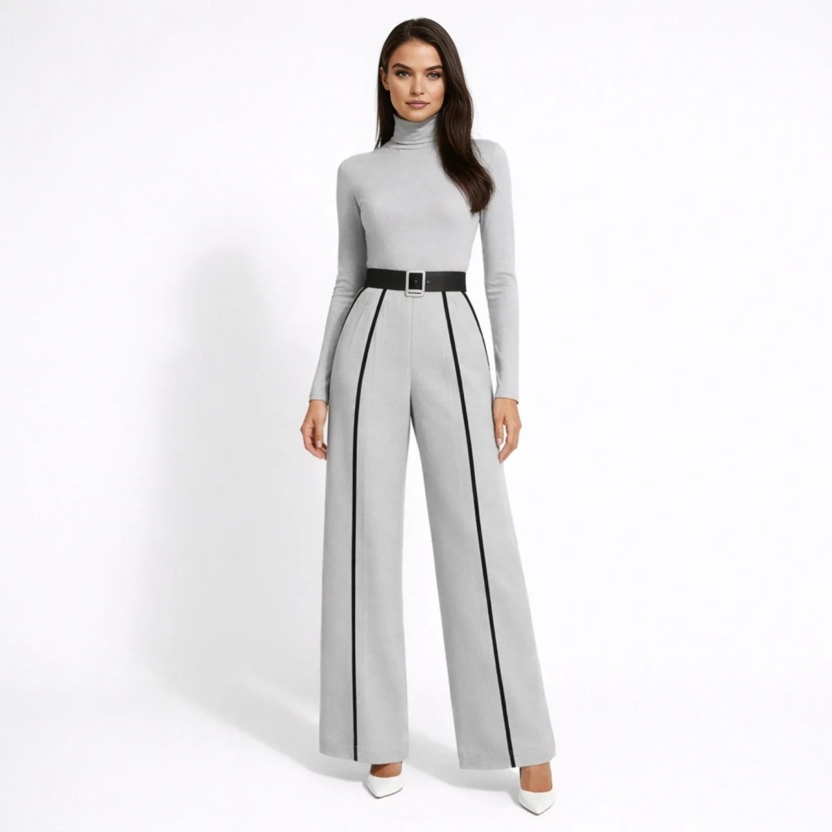 Front view of female model wearing the Kouvr grey long sleeve turtleneck wide leg jumpsuit with black contrast stripes and waist belt.