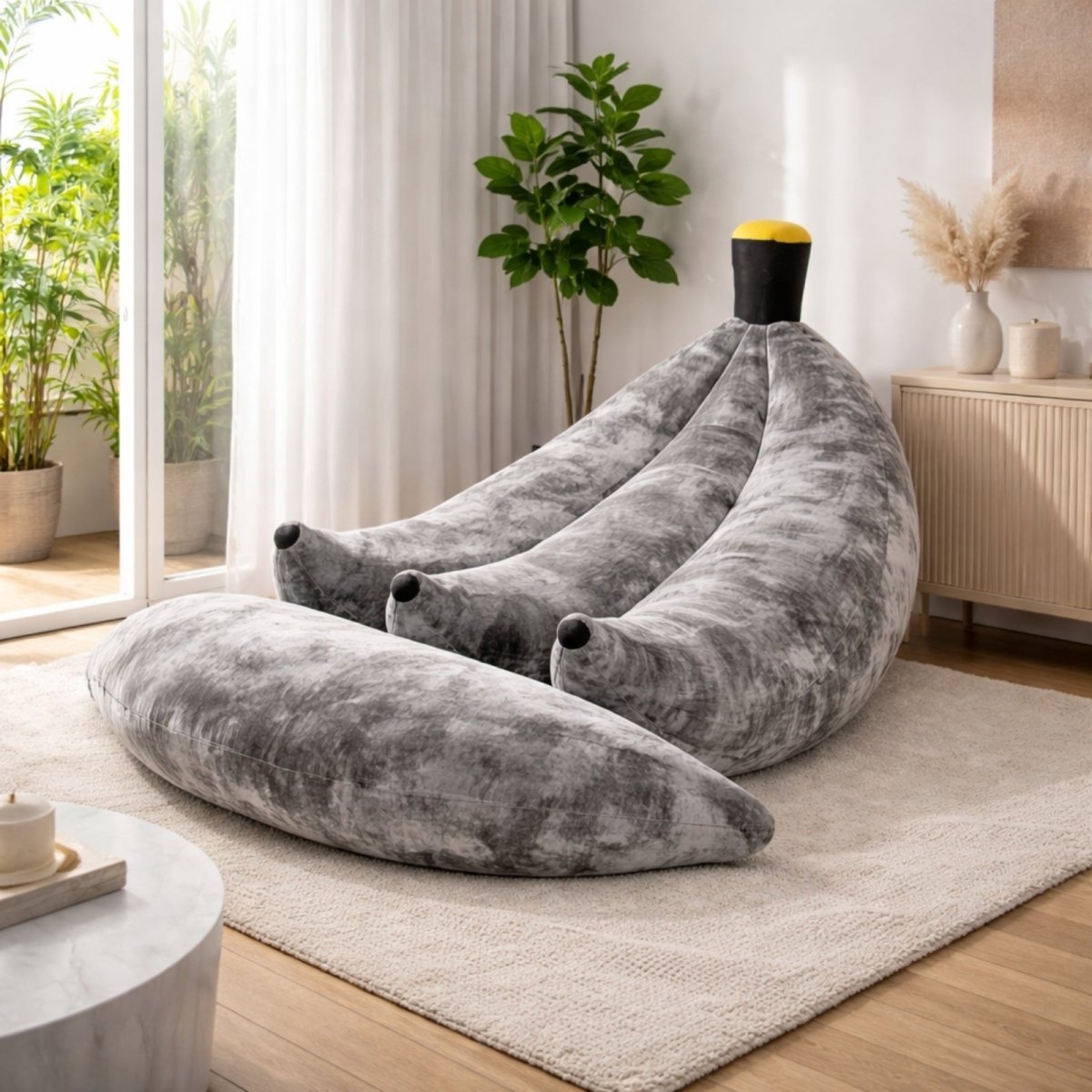 Silver grey banana shaped floor chair providing a neutral, sophisticated option for modern grey living spaces.