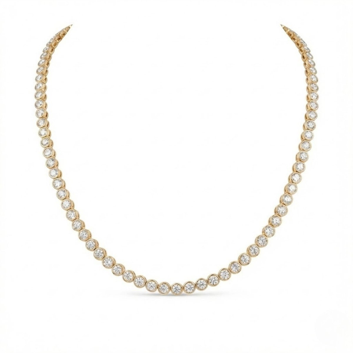 A 14k yellow gold bezel-set round diamond tennis necklace by Kouvr on a white background.