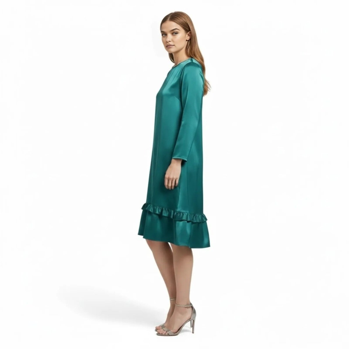 Side profile of a model in the Kouvr Adalee Teal satin knee-length dress showing its A-line silhouette.