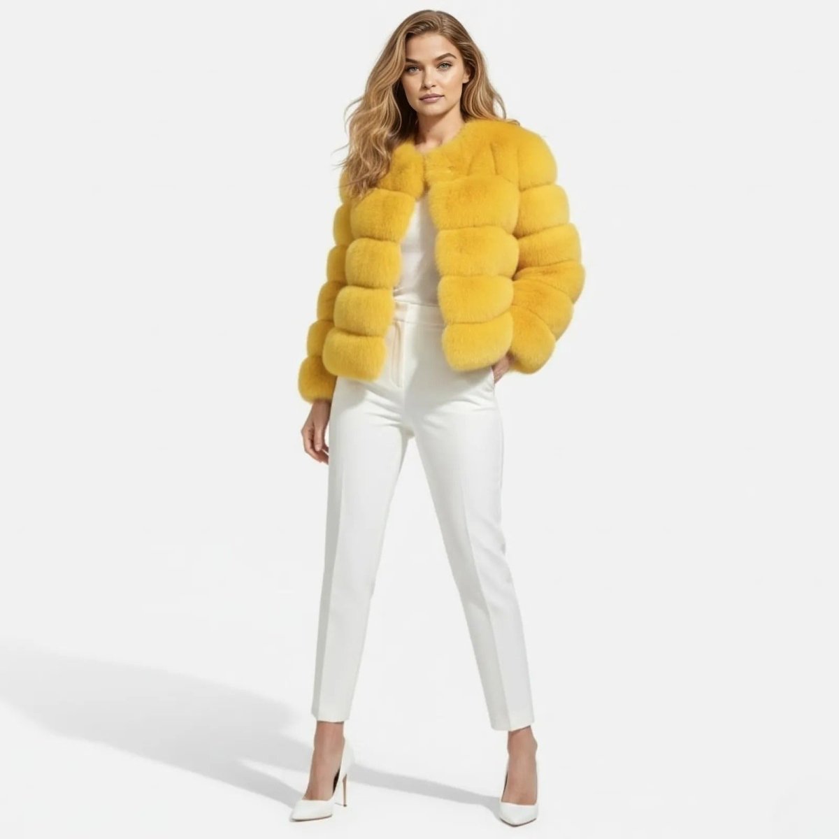 Model facing forward wearing the Alexia yellow panelled faux fur jacket with a white top, white trousers, and white heels against a white studio background.