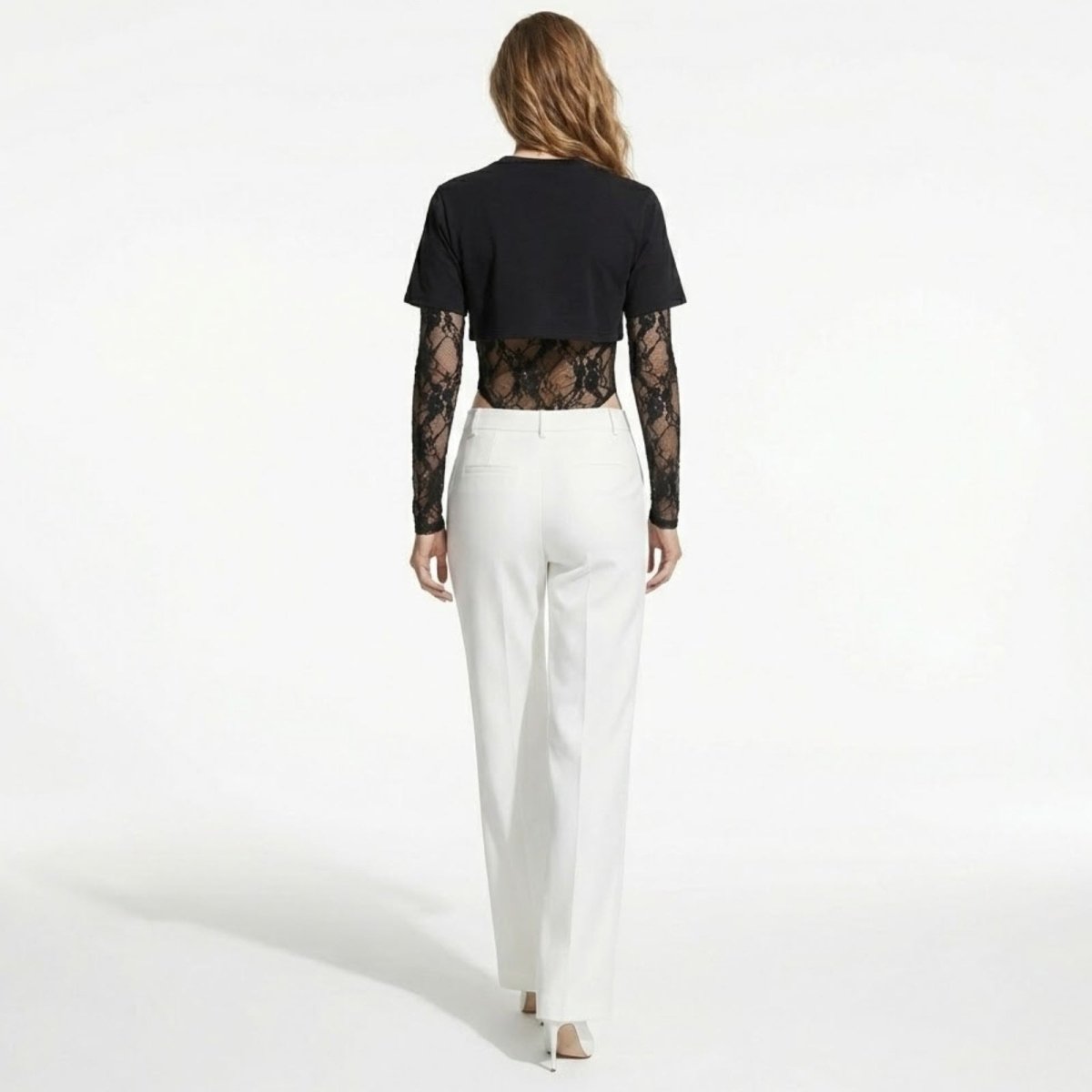 Back view of a model wearing the Kouvr Fashion Angelique bodysuit, showcasing the sheer lace back and cropped t-shirt overlay.