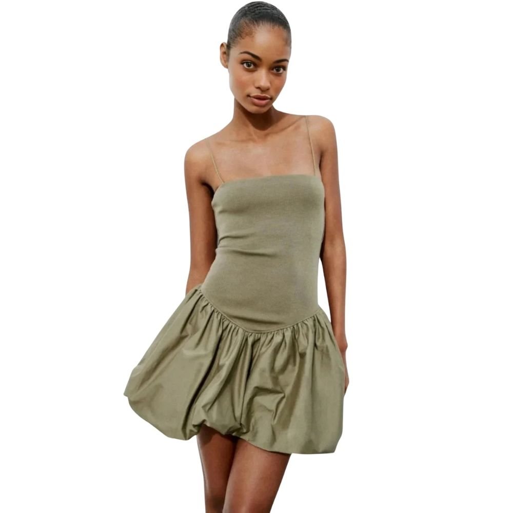 Woman wearing a strapless olive green kouvr dress on a white background