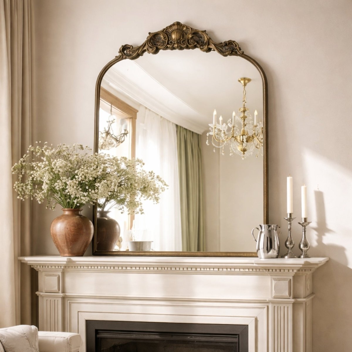 Close up of the ornate floral carving detail on the top arch of the Aveline mirror showing the textured metal finish.