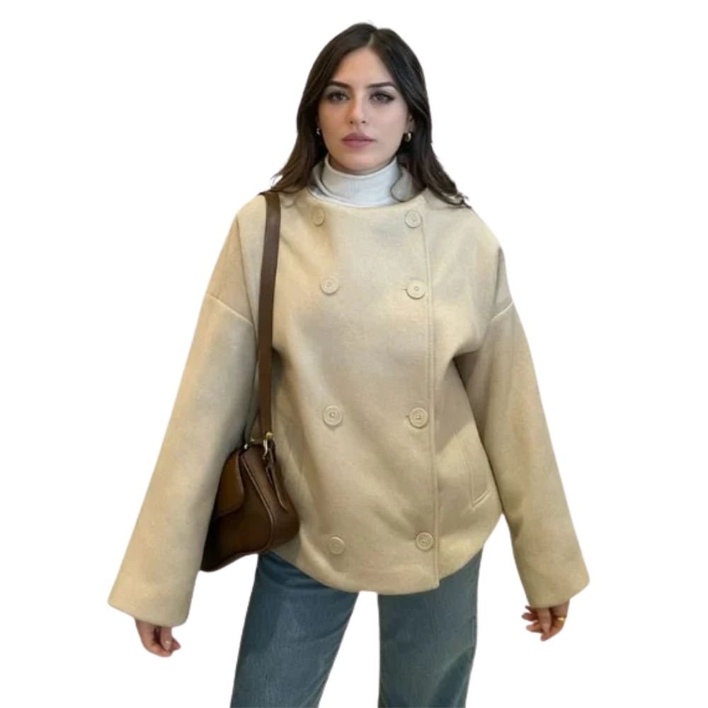 Model wearing the Kouvr beige cropped wool pea coat, styled with a turtleneck and blue jeans for an elevated casual look.