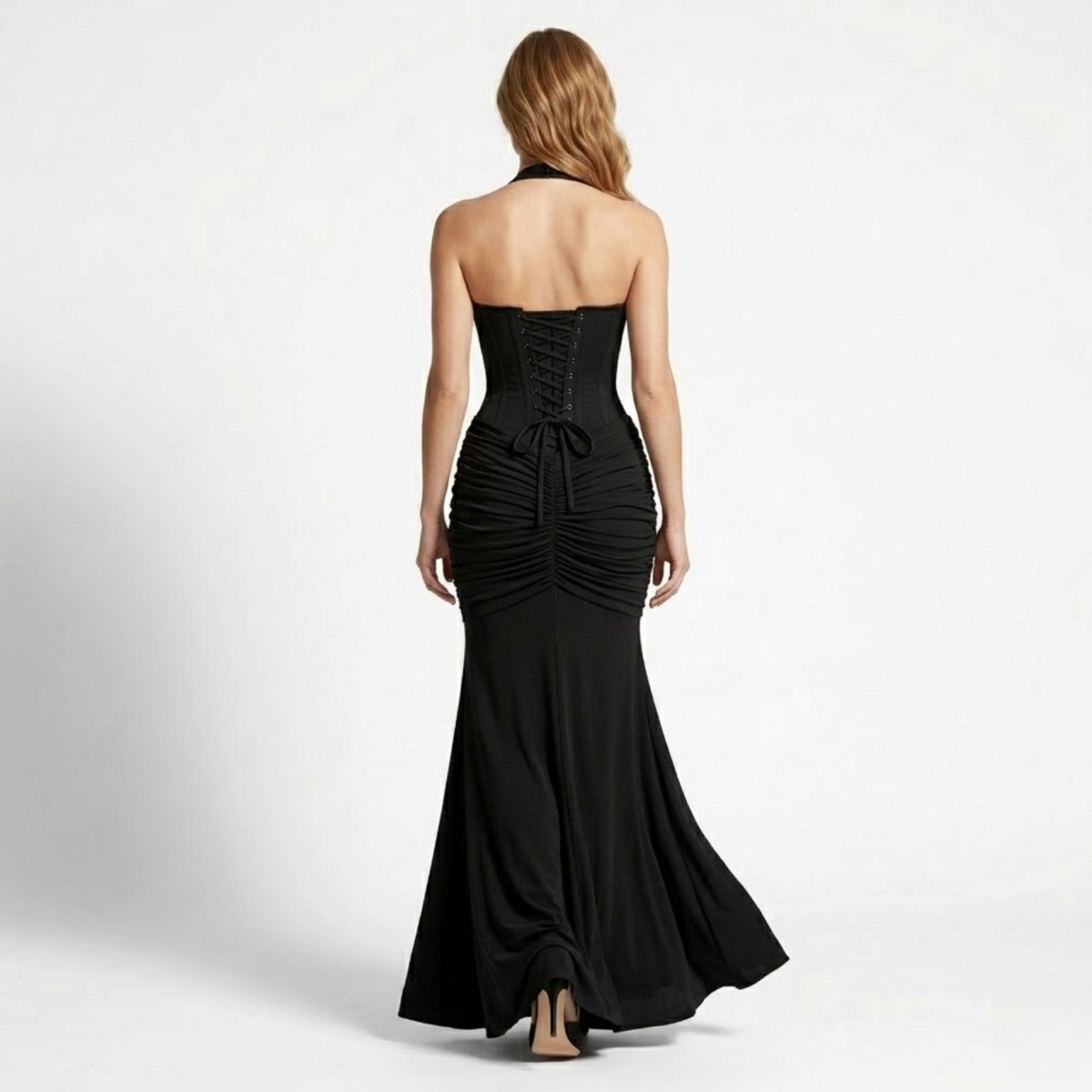 Back view of a sophisticated black formal maxi dress featuring a structured lace-up corset back tie and flowing train.