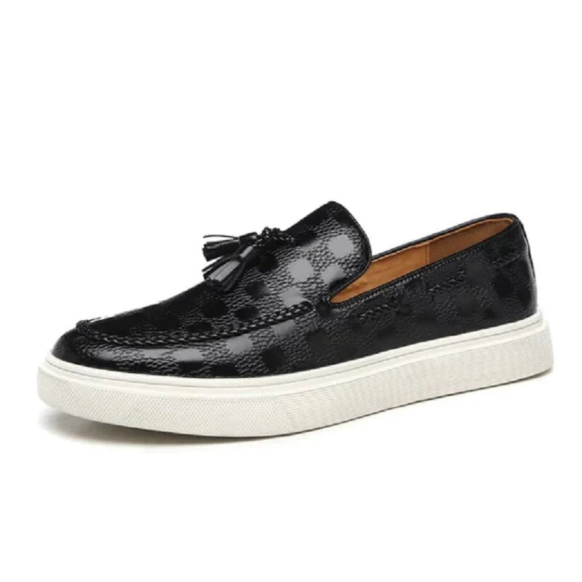 Side profile of the Kouvr Carlo black leather slip-on loafer showcasing the thick white comfort sole and handcrafted tassel detail.