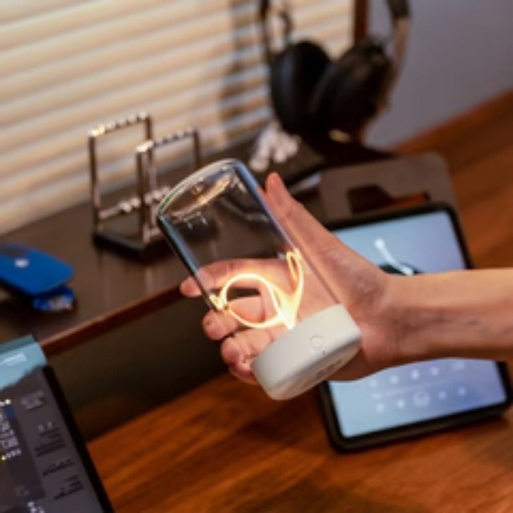 ambient lighting", "warm glow lamp", "minimalist home decor", "touch control light", "USB-C lamp", "portable centerpiece", "breathing light mode", "sculptural lighting", "hygge decor