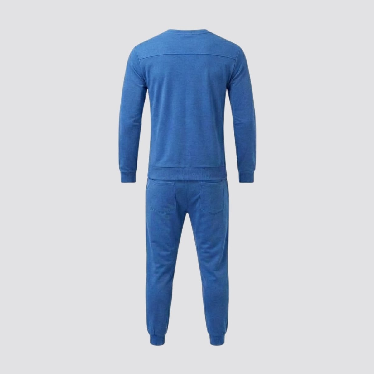 Back view of the blue Kouvr Crue tracksuit set, displaying the minimalist design and high-quality French terry cotton fabric.