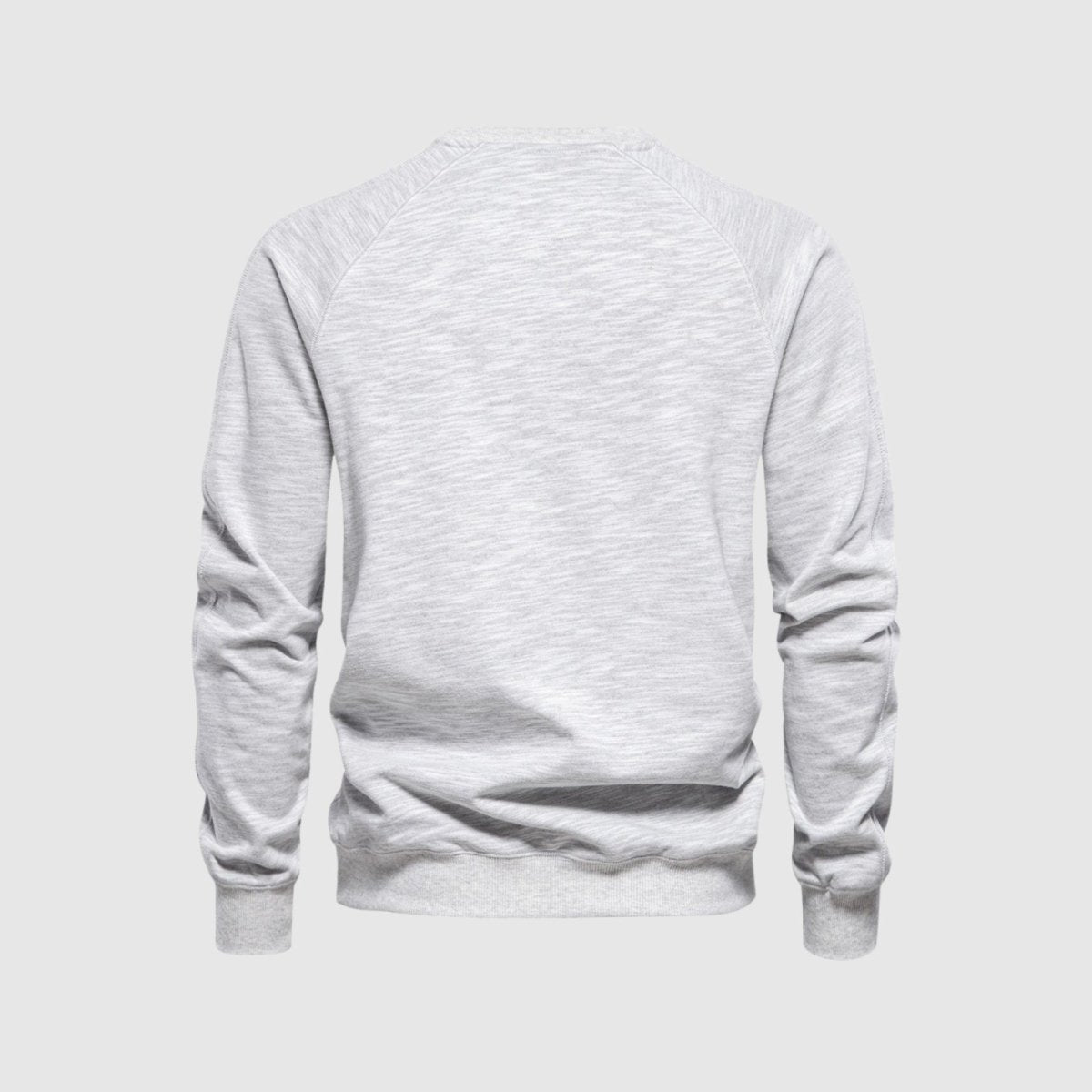 Back studio product shot of the Kouvr Deacon Crewneck Sweatshirt in heather light grey, showcasing the clean design and raglan sleeves.