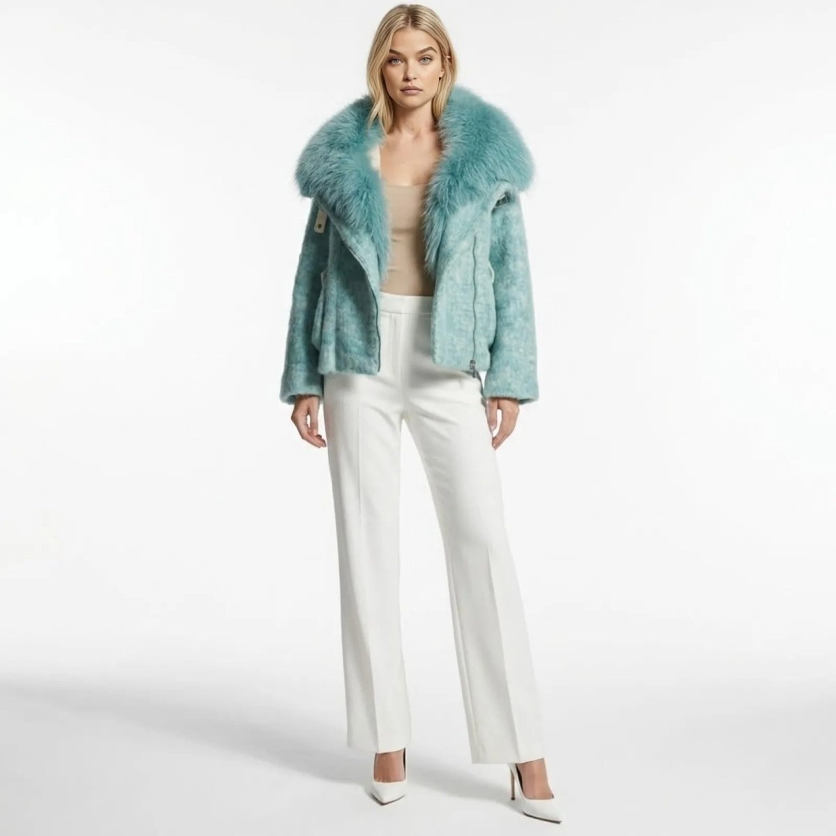 Model wearing the Kouvr Dorothy blue wool blend moto jacket with an oversized faux fur collar, styled with white wide-leg trousers and facing forward.