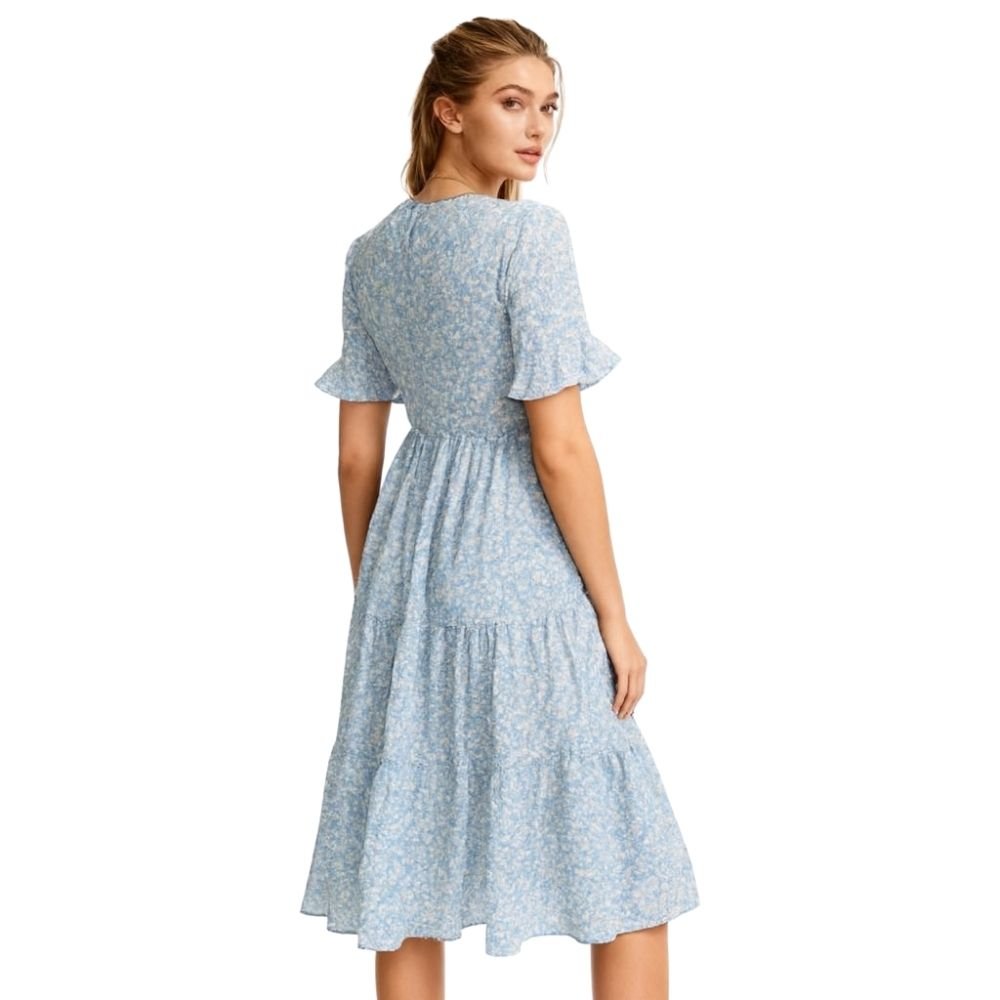 Woman wearing a kouvr light blue floral dress on a white background