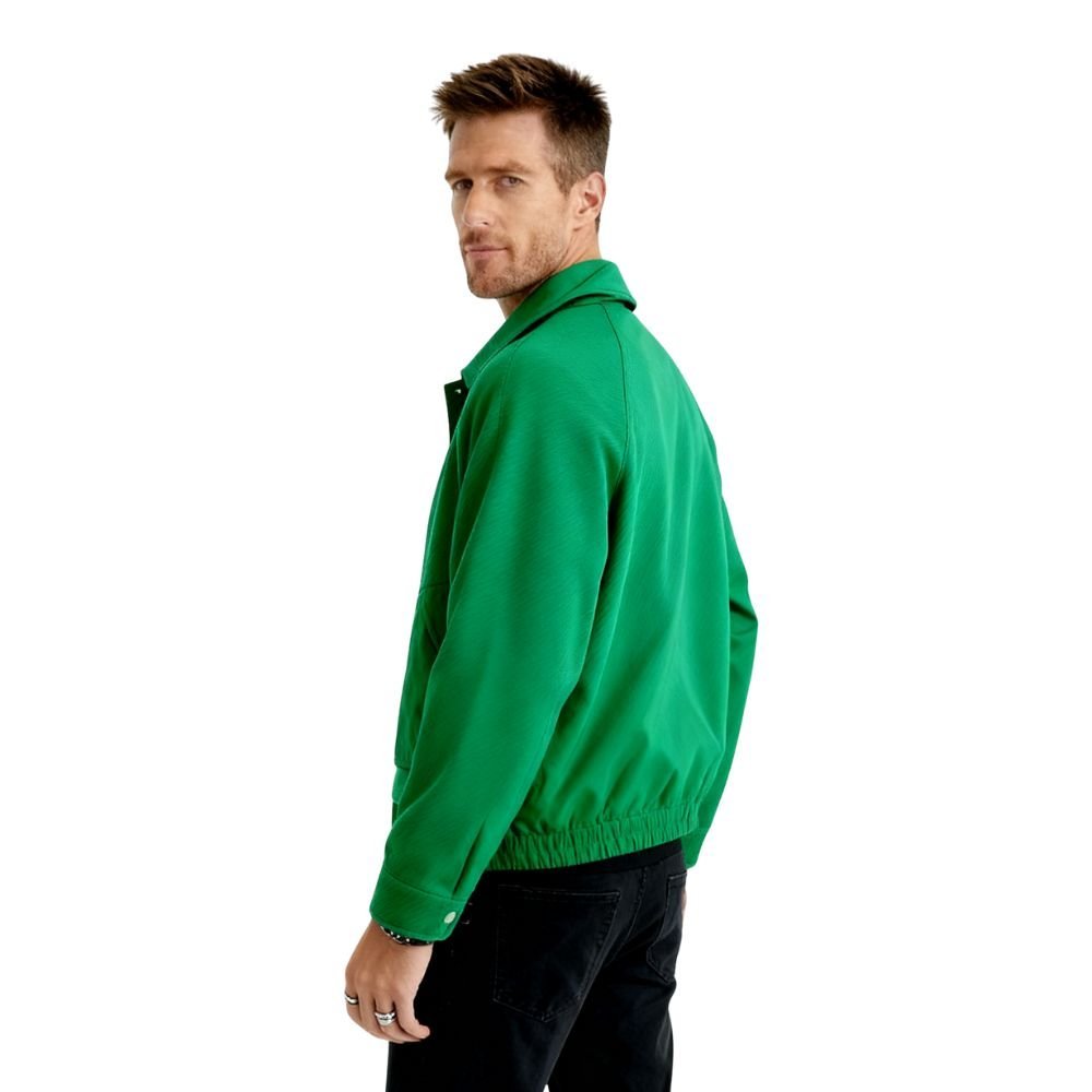 Man wearing a green kouvr jacket on a white background