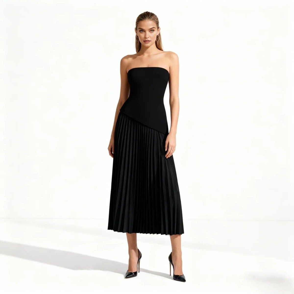 Woman wearing a black strapless dress on a white background