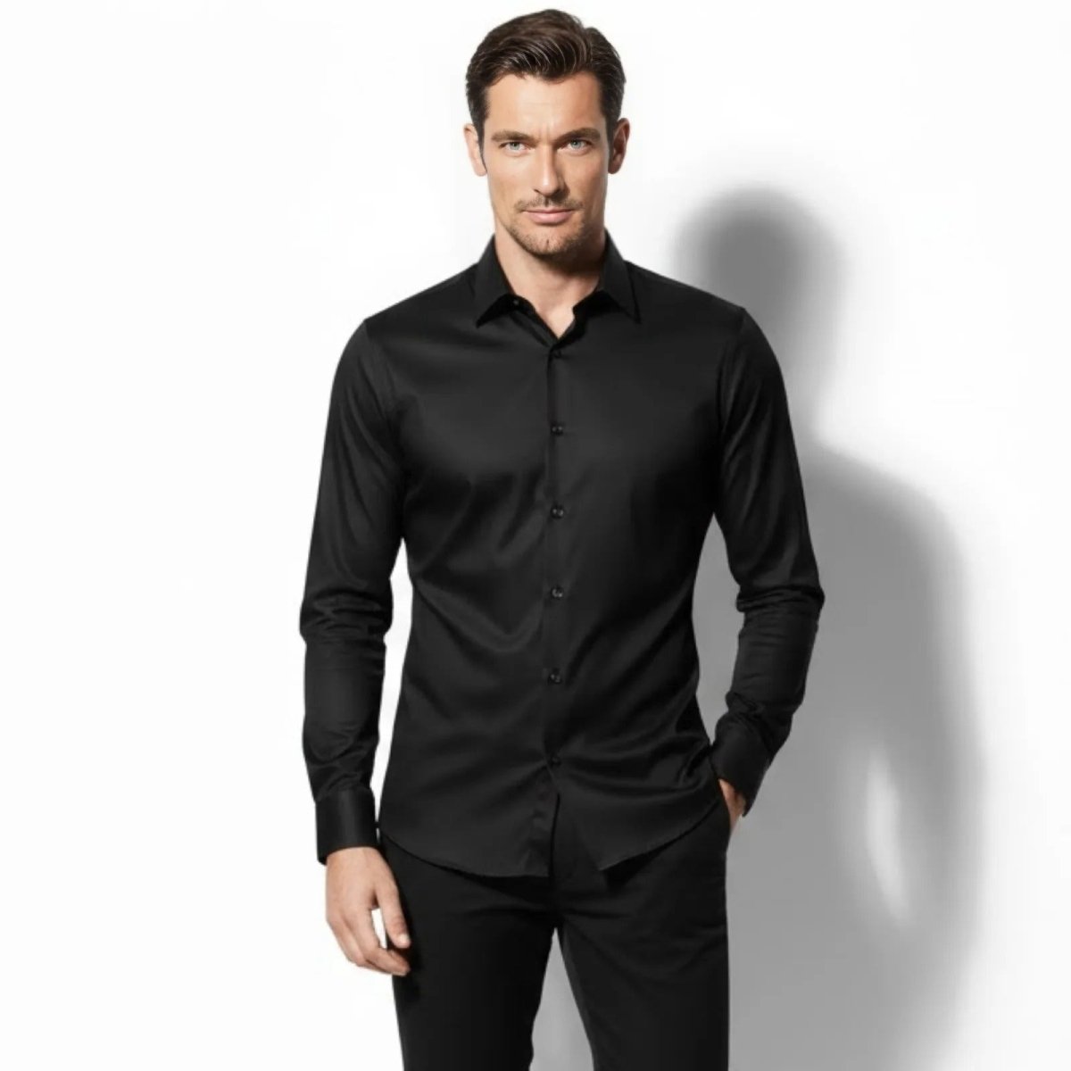Man wearing the Kouvr Fashion Briar slim fit black performance stretch dress shirt, looking directly at the camera with a white background.