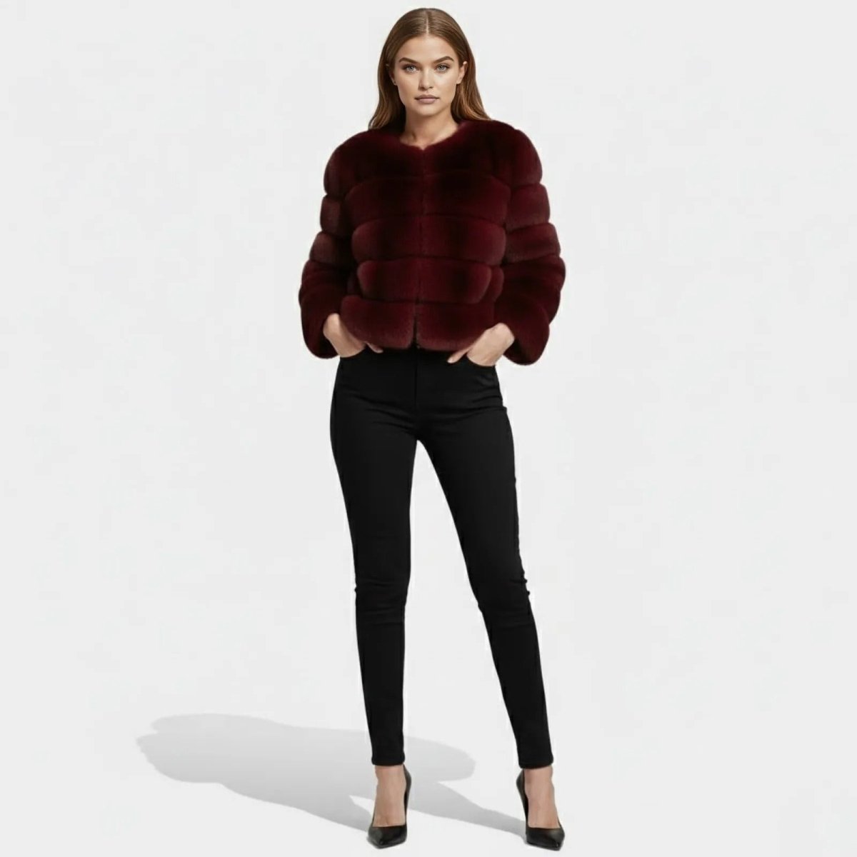 Model wearing the Kouvr Fashion burgundy cropped faux fur jacket with black pants, posed with hands in pockets.