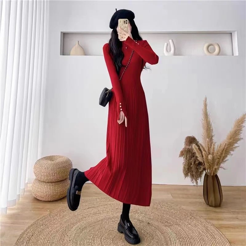 Woman wearing the statement red Dannah long sleeve pleated knit midi dress from Kouvr Fashion, styled with a black beret and loafers.