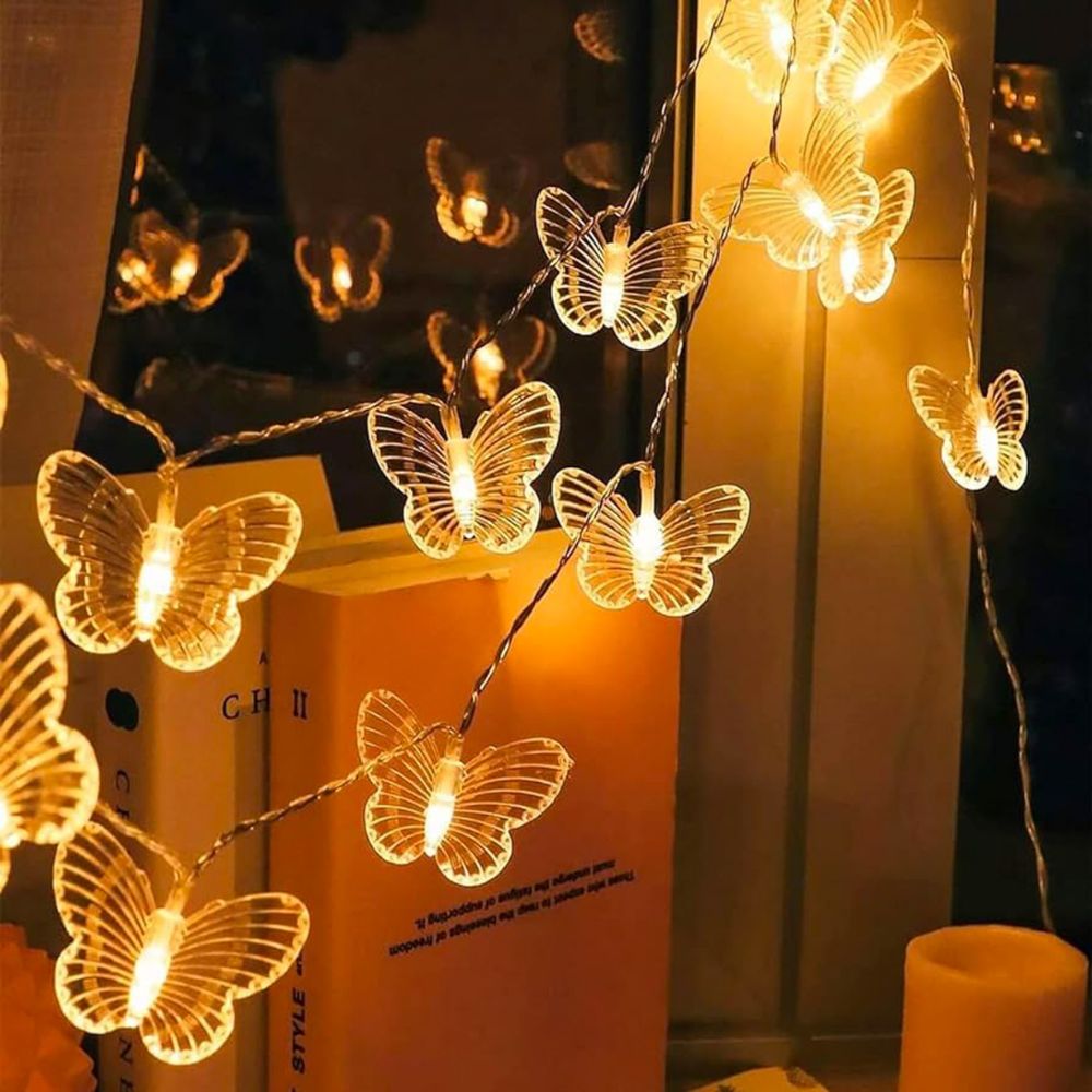 Kouvr Fashion's Fairy Flutter Lights creating a magical, romantic glow over a headboard in a luxury bedroom