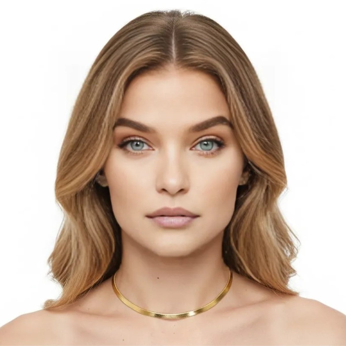 A woman with blonde hair and blue eyes wearing the Kouvr Fashion Amelie Gold Snake Chain Necklace to showcase its length and shine.