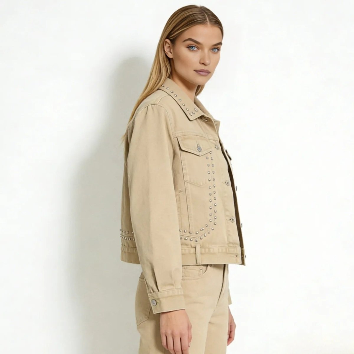 Side profile of a woman wearing the khaki studded Jacklyn jacket from Kouvr Fashion, highlighting the sleeve and body silhouette.