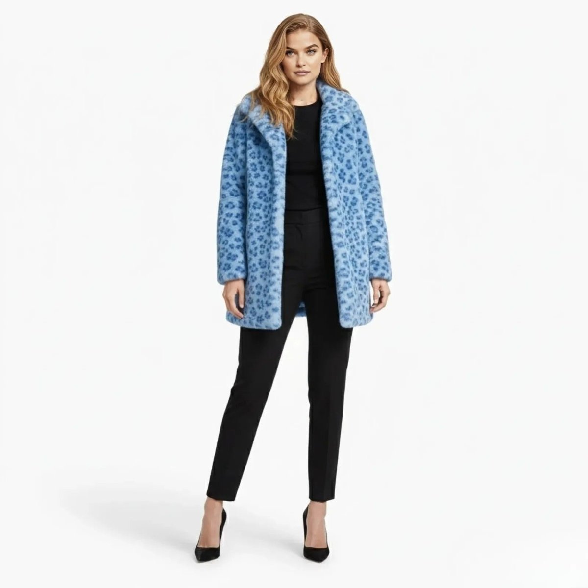 Model wears the Kouvr Fashion Jovi coat, a blue leopard print faux fur jacket, styled with black pants and heels, shown from the front against a white background.