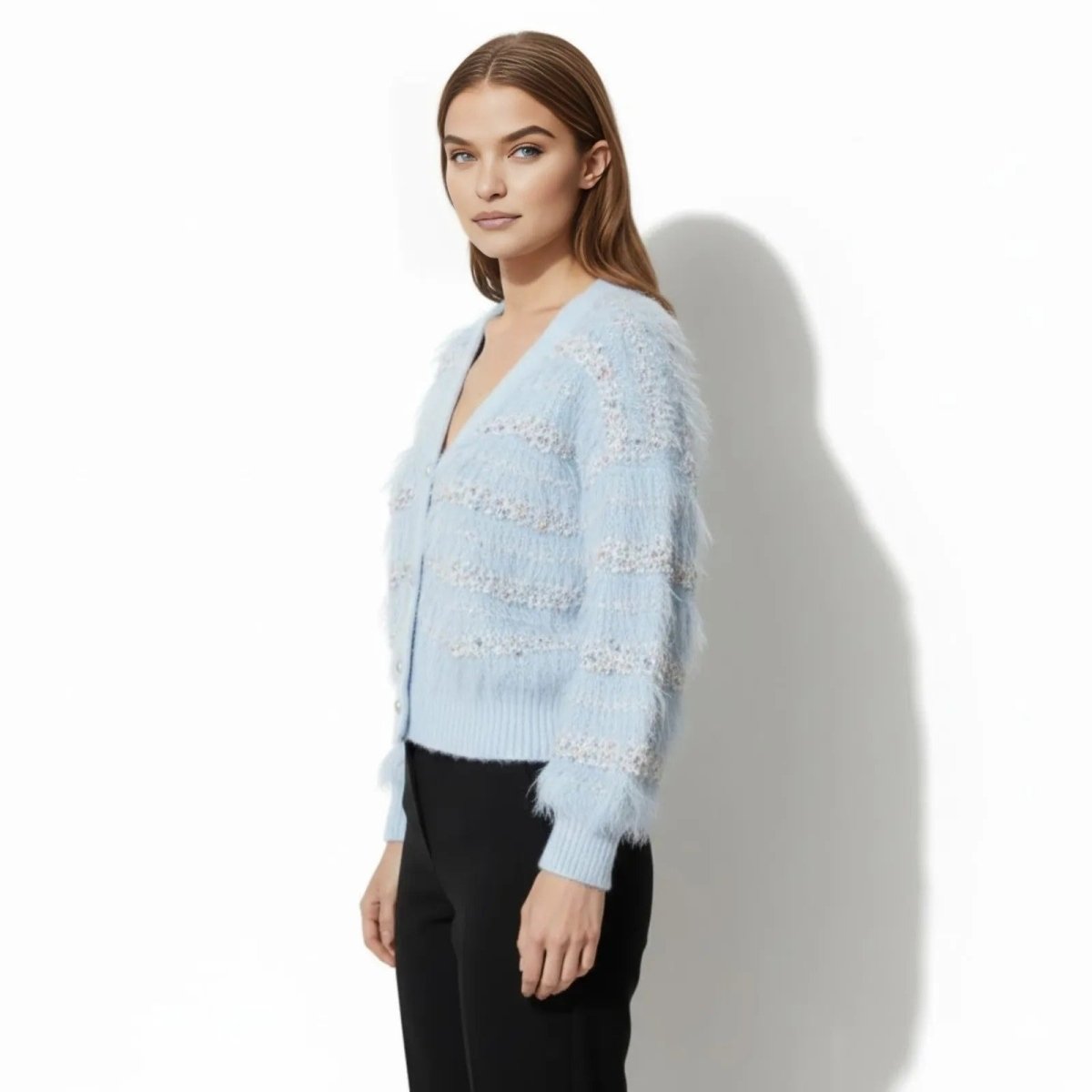 Side profile of a model wearing the Kouvr Fashion Kyra blue eyelash knit cardigan, showing the texture and sleeve volume.