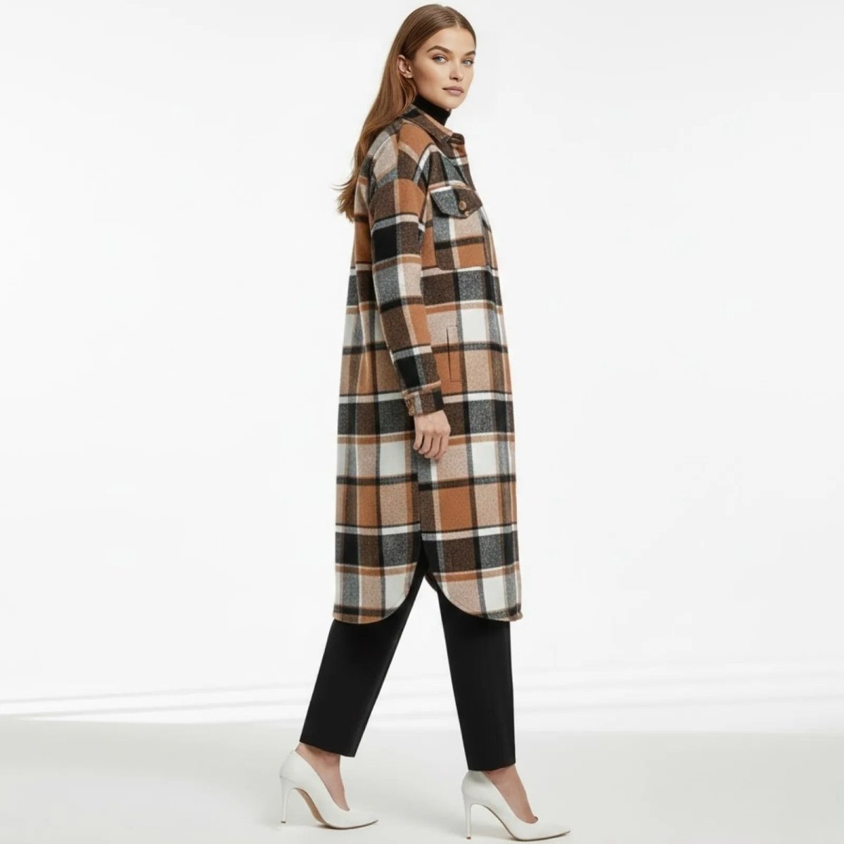 Side profile of a model walking in a brown plaid longline shirt jacket, showing the curved hem and side slit detail.