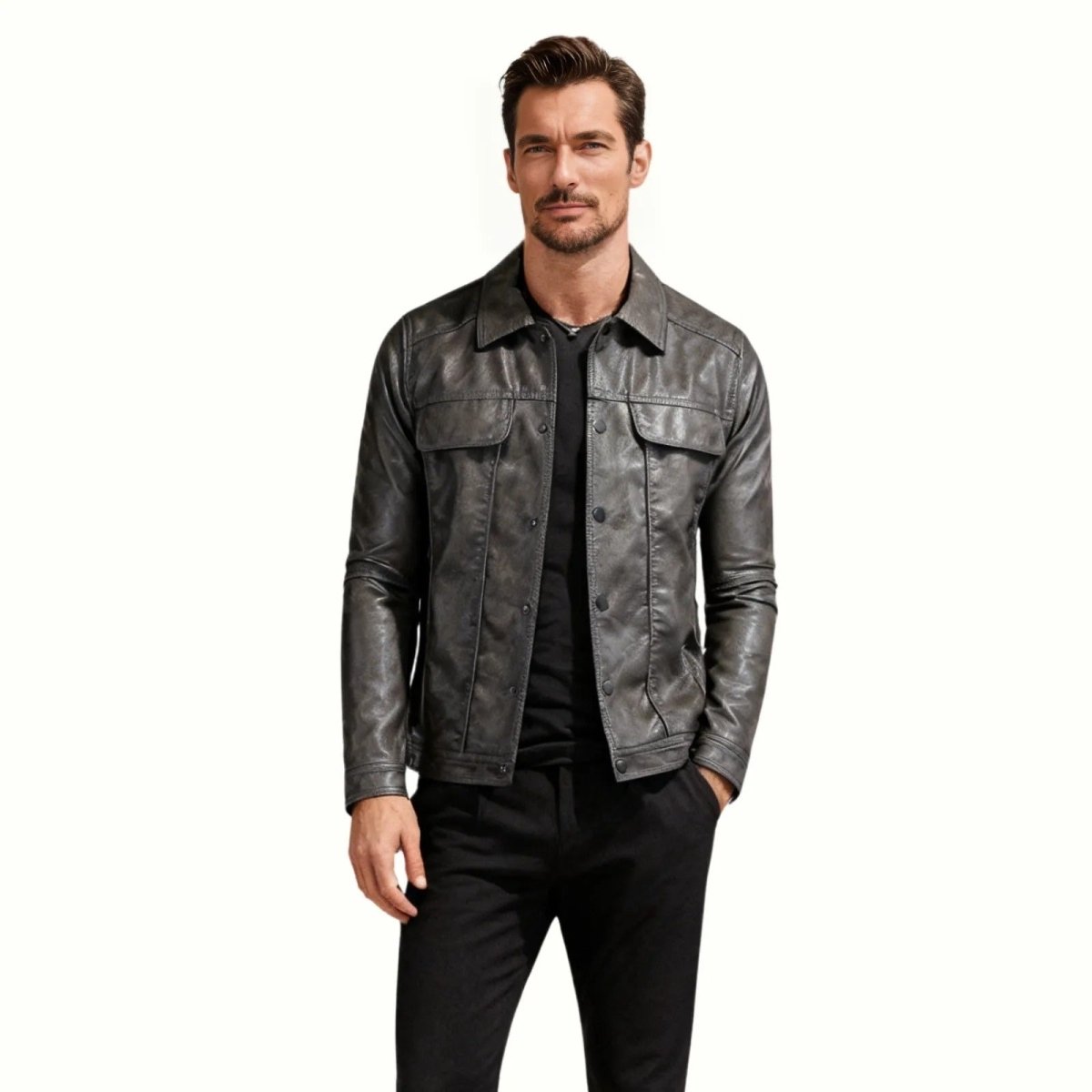 Man wearing the Kouvr Clinton men's dark grey leather trucker jacket with black pants.