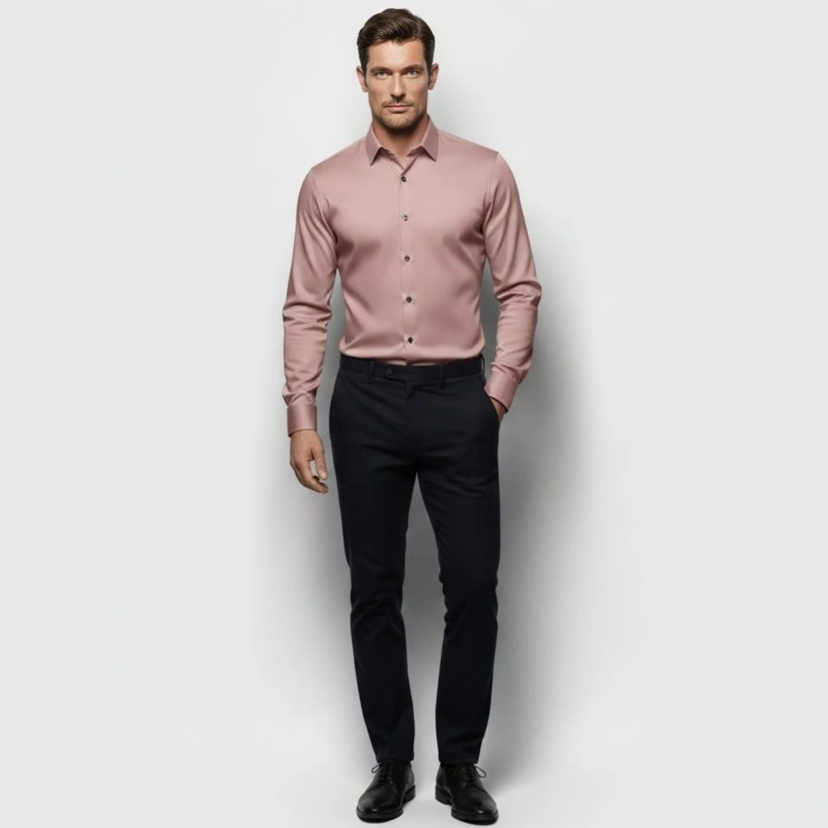 Male model wearing the Kouvr Fashion pink slim fit dress shirt with dark trousers, showing the front view and sateen fabric finish.