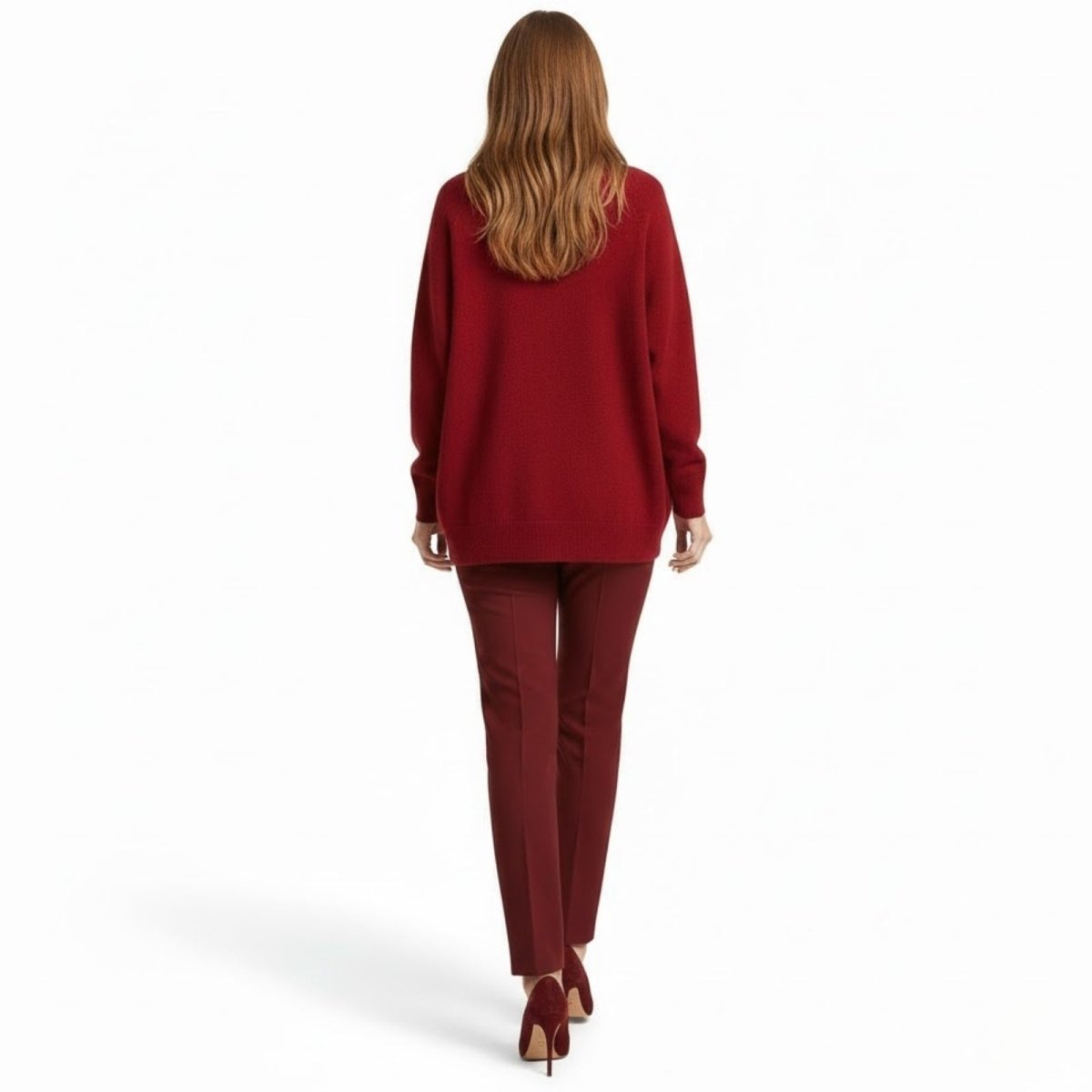 Back view of a model walking away wearing the Kouvr Fashion crimson red oversized sweater and matching trousers.