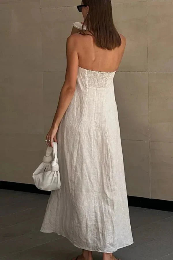 Model from behind wearing the Kouvr Fashion strapless linen maxi dress showing the smocked back detail