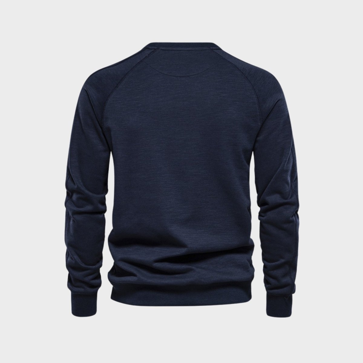 Back view of the Kouvr Fashion Deacon navy blue sweater laid flat, highlighting the raglan sleeves and ribbed hem.