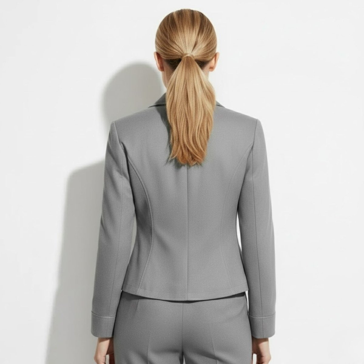 Back view of the Kouvr Fashion grey blazer for women, highlighting the shaping from the princess seams.