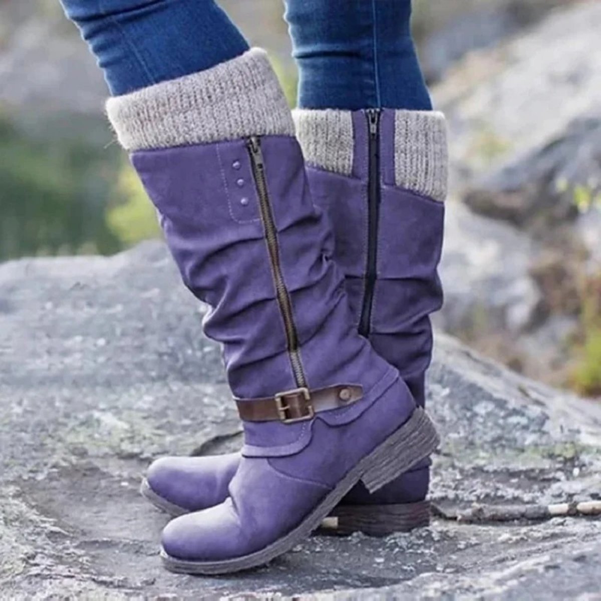 Lilac boots with gray cuffs worn on a rocky surface