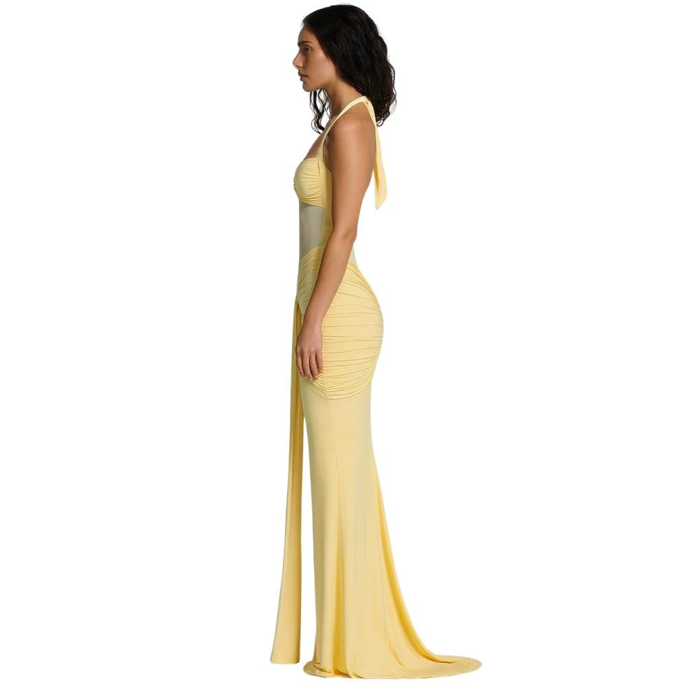 Model wearing the Kouvr Fashion yellow halter neck maxi gown with sheer midriff panel and draped skirt