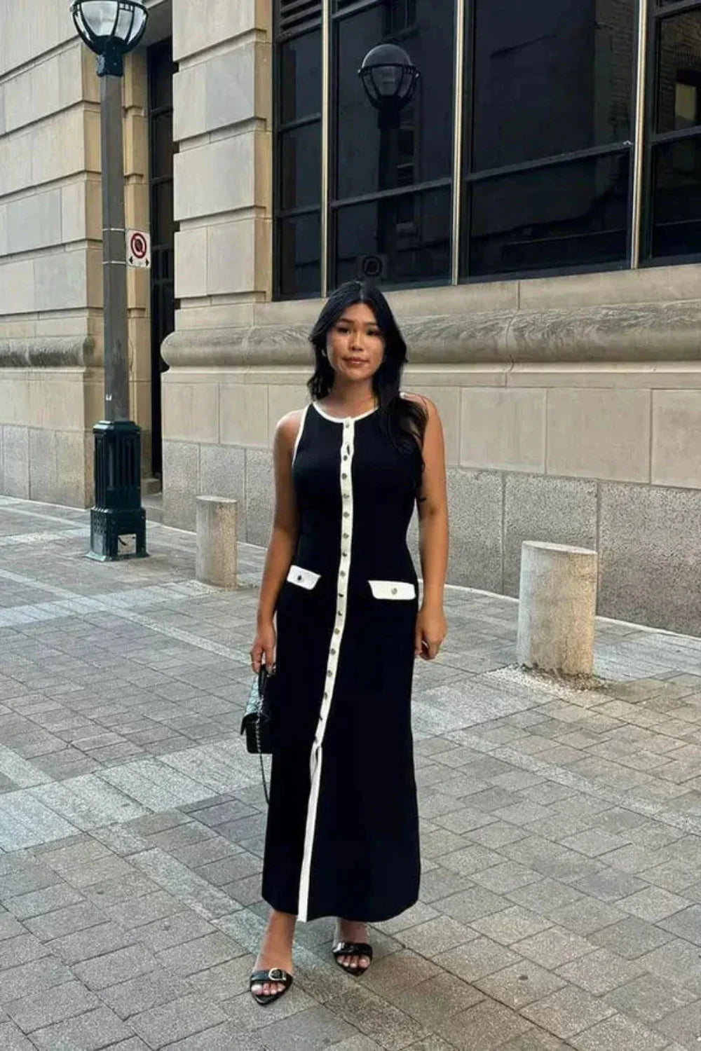 Kouvr Fashion Fiorella Knit Midi Dress in black worn by a model on a city street