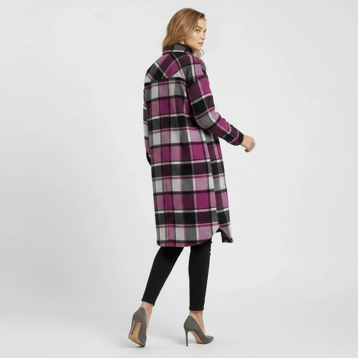 Back view of a woman wearing the Kouvr grey and black plaid shacket, highlighting the pattern alignment and shirttail hem.