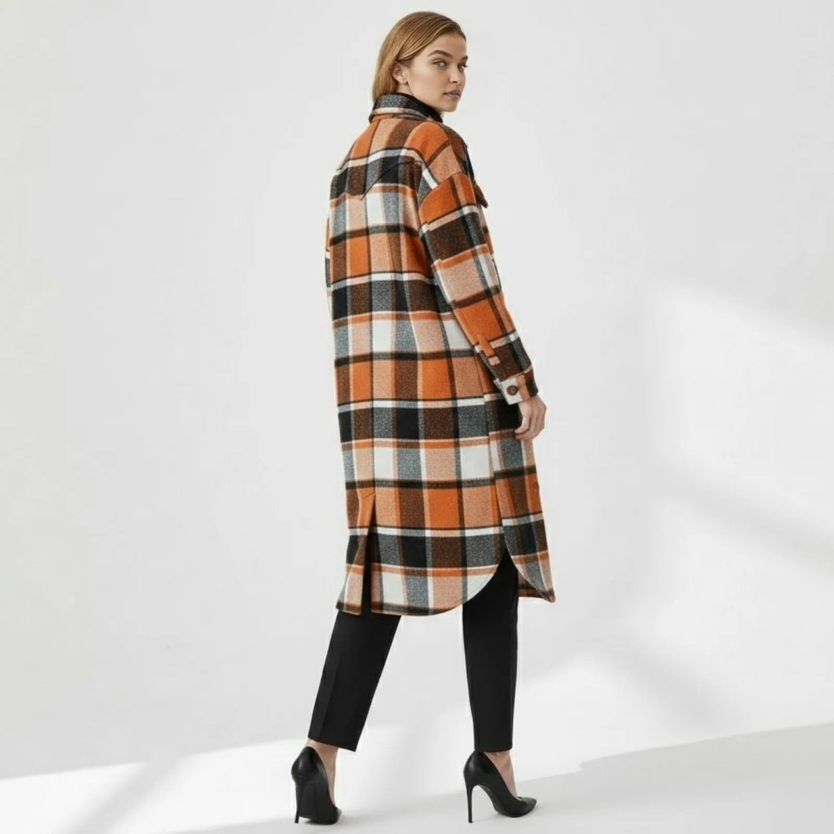 Back view of a woman wearing the Kouvr Janet Longline Plaid Shacket, highlighting the western yoke detail and plaid pattern.