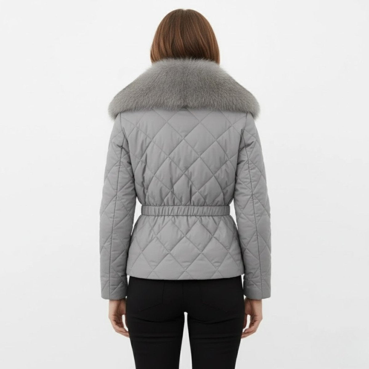 Back view of the Kayla grey quilted jacket showing the cinched elasticated waist detail and full fur collar.