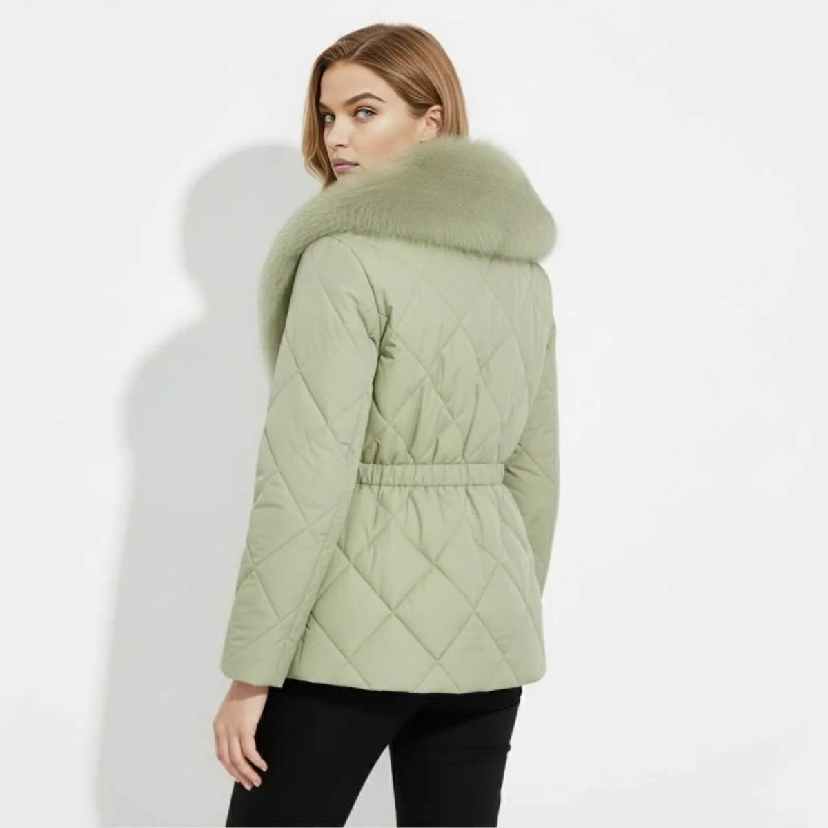 Back view of the Kouvr Kayla jacket in sage green, highlighting the elasticated cinched waistband and full fur collar.