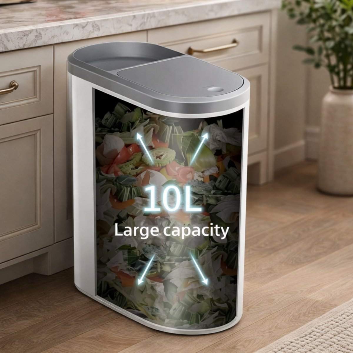A cross-section view of the Kouvr trash can illustrating its large 10L capacity filled with vegetable scraps in a modern kitchen.