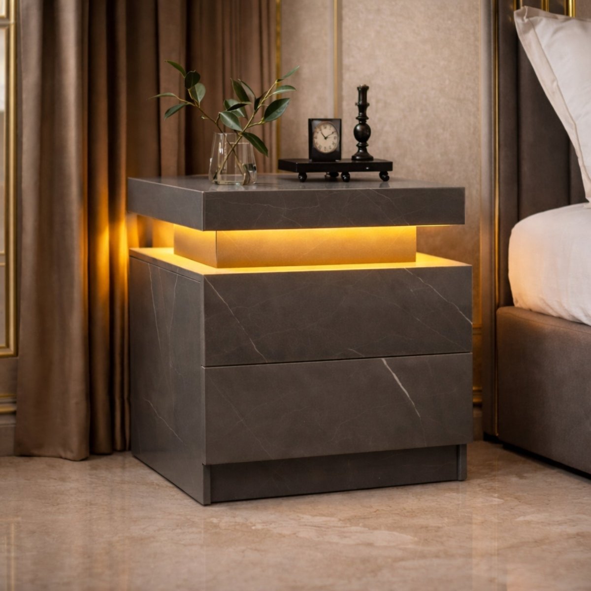The Kouvr Lumina side table in a light marble finish, featuring warm LED ambient lighting, styled next to a beige sofa in a classic luxury living room.