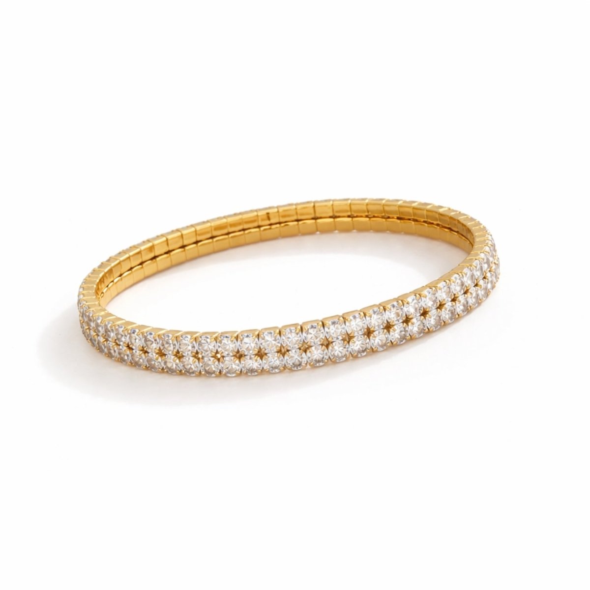An angled view of the Kouvr Marzanna double row crystal tennis bracelet showing its flexible gold link construction.