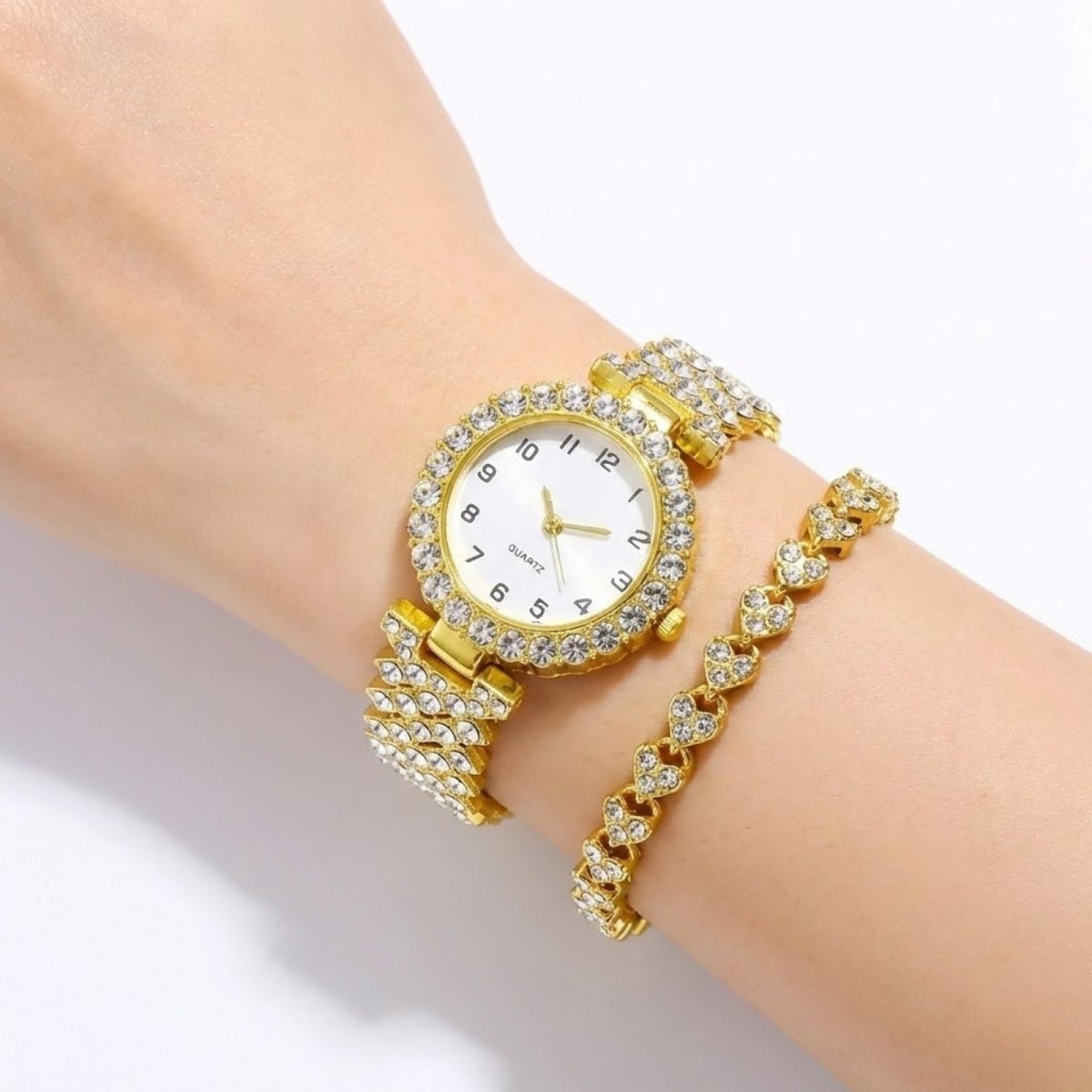 Lifestyle view of the Kouvr gold watch and bracelet set on a model's arm against a dark, luxurious background.