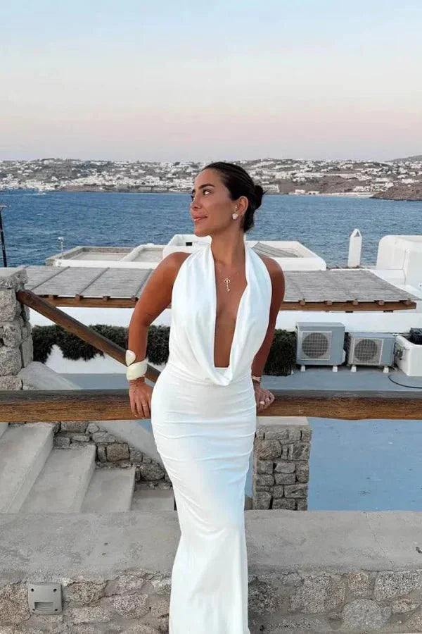 Model wearing the white satin backless Meliora Gown by Kouvr Fashion