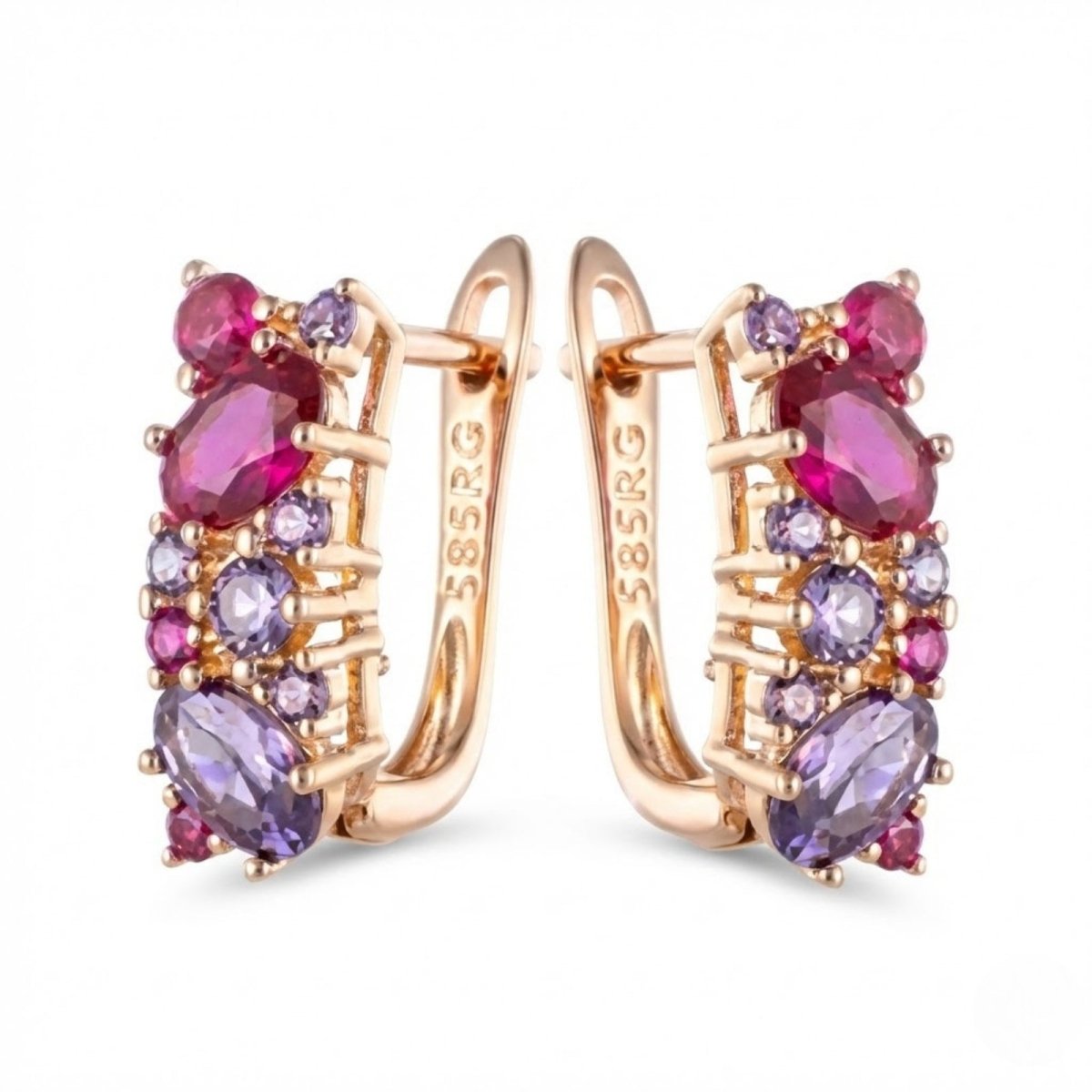 A pair of Kouvr Millie 14K rose gold huggie earrings with a cluster of vibrant ruby and amethyst gemstones on a white background.