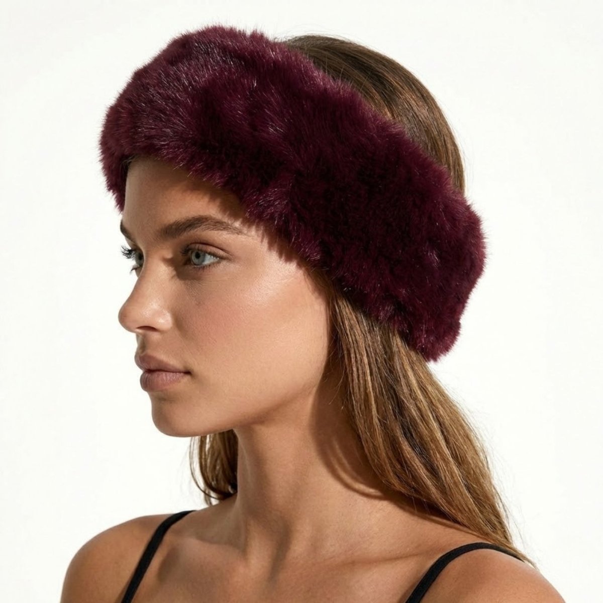 Side profile of a model wearing the Kouvr Nancie plush burgundy faux fur winter headband.