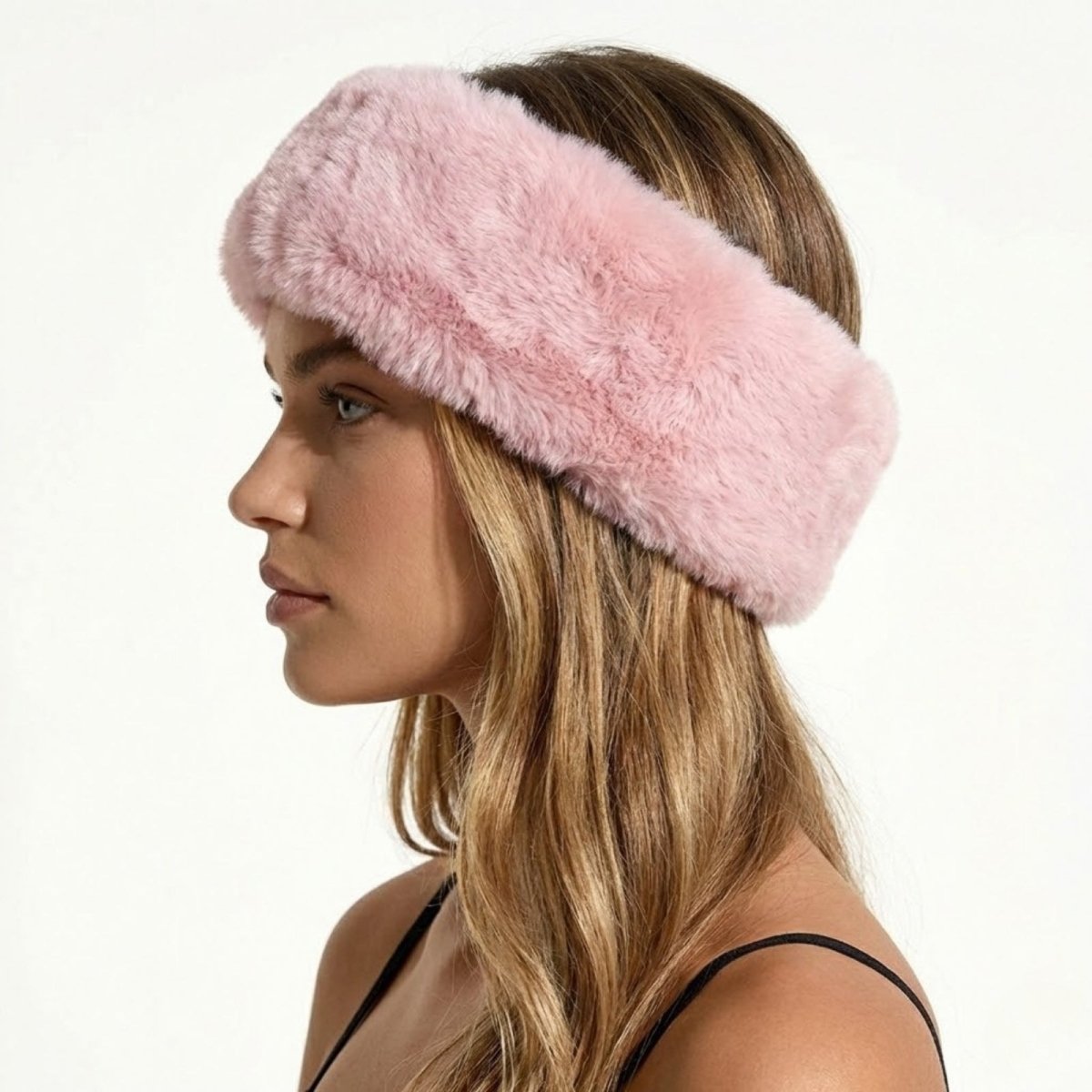 Side profile of a model wearing the Kouvr Nancie plush pink faux fur winter headband.