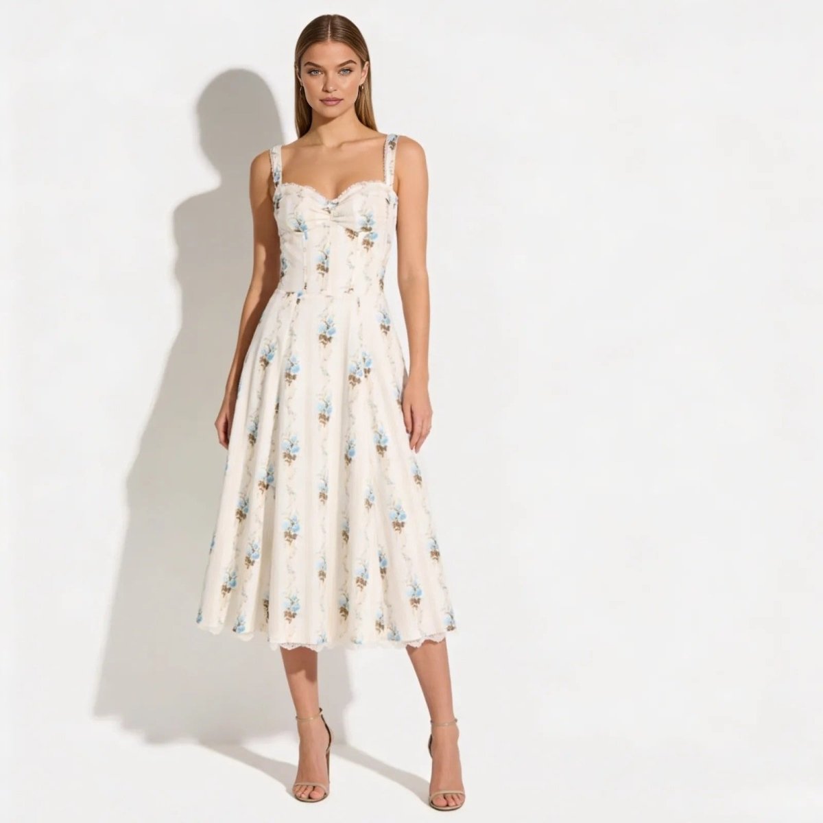 Model wearing the Kouvr Nefeli cream floral corset midi dress with a sweetheart neckline and A-line skirt, shown from the front against a white background.
